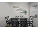 Dining area with black table and six chairs at 2465 Sturrock Dr, Henderson, NV 89044