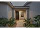 Front entry with a security door, window, and landscaping at 2465 Sturrock Dr, Henderson, NV 89044