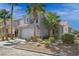 Two-story house with gray exterior, two-car garage, and palm trees at 2465 Sturrock Dr, Henderson, NV 89044