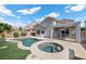 Relaxing backyard with a pool, spa, and covered patio at 2465 Sturrock Dr, Henderson, NV 89044