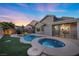 Relaxing backyard oasis featuring a pool and spa, surrounded by lush landscaping at 2465 Sturrock Dr, Henderson, NV 89044