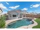 Home's backyard oasis featuring a pool, spa, and grassy area at 2465 Sturrock Dr, Henderson, NV 89044