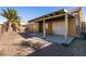 Covered patio and gravel backyard with a palm tree at 2535 River Oaks Dr, Las Vegas, NV 89156