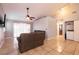 Living room with tiled floors, sliding doors, and a ceiling fan at 2535 River Oaks Dr, Las Vegas, NV 89156