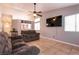 Living area with tiled floors, a large TV, and a ceiling fan at 2535 River Oaks Dr, Las Vegas, NV 89156