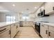 Modern kitchen with white cabinets, quartz countertops, and stainless steel appliances at 2670 Zephyr Ave, Pahrump, NV 89048