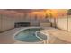 Kidney-shaped swimming pool with a white fence and fire pit at 2670 Zephyr Ave, Pahrump, NV 89048