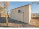 Tan colored storage shed with window at 2670 Zephyr Ave, Pahrump, NV 89048