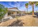 Sunny backyard, covered patio, and gravel at 2674 Alwoodley Cir, Las Vegas, NV 89142