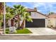 House exterior with a red door and lush landscaping at 2674 Alwoodley Cir, Las Vegas, NV 89142