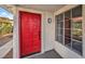 Red front door with a multi-pane window beside it at 2674 Alwoodley Cir, Las Vegas, NV 89142