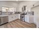 Modern kitchen with white cabinets, stone backsplash, and stainless steel appliances at 2674 Alwoodley Cir, Las Vegas, NV 89142