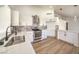 Modern kitchen with white cabinets, quartz countertops, and stainless steel appliances at 2674 Alwoodley Cir, Las Vegas, NV 89142