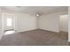 Living room with grey carpet, ceiling fan, and entryway view at 2728 Pavehawk Way, Las Vegas, NV 89156