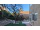 Landscaped backyard with a tree and retaining wall at 2849 Huber Heights Dr, Las Vegas, NV 89128