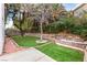 Landscaped backyard with stone retaining walls at 2849 Huber Heights Dr, Las Vegas, NV 89128