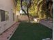 Artificial turf backyard with a brick pathway at 2849 Huber Heights Dr, Las Vegas, NV 89128