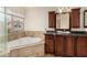 Elegant bathroom with granite vanity and corner tub at 2849 Huber Heights Dr, Las Vegas, NV 89128