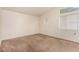 Simple carpeted bedroom with window and neutral walls at 2849 Huber Heights Dr, Las Vegas, NV 89128