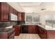 Kitchen features dark wood cabinets, granite countertops, and a built-in microwave at 2849 Huber Heights Dr, Las Vegas, NV 89128