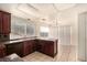 Spacious kitchen with dark wood cabinets, granite counters, and stainless steel appliances at 2849 Huber Heights Dr, Las Vegas, NV 89128