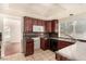 View of kitchen with dark wood cabinets, granite countertops and a double sink at 2849 Huber Heights Dr, Las Vegas, NV 89128