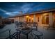 Backyard patio with seating, dining, and lounge areas at night at 3361 Winery Rd, Pahrump, NV 89048