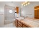 Clean bathroom with pink tile, bathtub, and wood vanity at 3361 Winery Rd, Pahrump, NV 89048