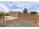 Long driveway leading to a home with a high block wall for privacy at 3361 Winery Rd, Pahrump, NV 89048