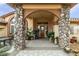 Elegant entryway with stone columns, arched entry, and potted plants at 3361 Winery Rd, Pahrump, NV 89048