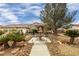 House with a fountain and nicely landscaped yard, offering curb appeal at 3361 Winery Rd, Pahrump, NV 89048