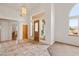 Bright foyer with tiled floors, chandelier, and entry to other rooms at 3361 Winery Rd, Pahrump, NV 89048