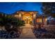 Night view of house entrance with stone accents and landscaping at 3361 Winery Rd, Pahrump, NV 89048