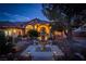 Eveneing view of the front yard, featuring a fountain and landscaping at 3361 Winery Rd, Pahrump, NV 89048