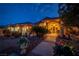 House entrance with walkway, landscaping, and lighting at night at 3361 Winery Rd, Pahrump, NV 89048