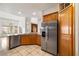 Kitchen features stainless steel refrigerator and oak cabinetry at 3361 Winery Rd, Pahrump, NV 89048