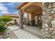 Covered patio with a stone-accented sitting area and fountain at 3361 Winery Rd, Pahrump, NV 89048