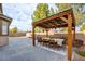 Cozy backyard patio featuring a covered dining area, modern pavers, and string lights for outdoor entertaining at 3402 Arcata Point Ave, Las Vegas, NV 89141