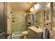 Bathroom with updated vanity, shower, and stone tile at 3402 Arcata Point Ave, Las Vegas, NV 89141