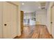 Upstairs landing with hardwood floors, neutral walls, and modern chandelier, bathed in natural light at 3402 Arcata Point Ave, Las Vegas, NV 89141