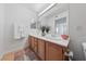 Double vanity bathroom with wood cabinets and updated lighting at 3425 E Russell Rd # 121, Las Vegas, NV 89120