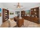 Virtually staged home office with built-in shelving and hardwood floors at 3425 E Russell Rd # 121, Las Vegas, NV 89120