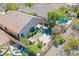 Aerial view showcasing the backyard with patio, hot tub, lush greenery, and sparkling pool at 36 Hunt Valley Trl, Henderson, NV 89052