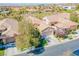 A neighborhood view, showcasing well-maintained homes with tile roofs and green landscaping at 36 Hunt Valley Trl, Henderson, NV 89052