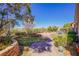 Landscaped backyard with hot tub, circular patio, and manicured lawn at 36 Hunt Valley Trl, Henderson, NV 89052