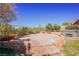 Landscaped backyard featuring a hot tub and flagstone patio at 36 Hunt Valley Trl, Henderson, NV 89052