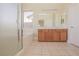 Bright bathroom featuring double vanity, large mirror, tub, and glass shower at 36 Hunt Valley Trl, Henderson, NV 89052
