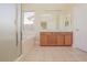 Bright bathroom featuring a double vanity, large mirror, soaking tub, and separate glass shower, exuding a spa-like ambiance at 36 Hunt Valley Trl, Henderson, NV 89052