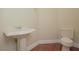 Pedestal sink and toilet in a stylish half bathroom at 36 Hunt Valley Trl, Henderson, NV 89052