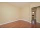An empty bedroom with hardwood floors and light yellow walls offers a neutral, adaptable living space at 36 Hunt Valley Trl, Henderson, NV 89052